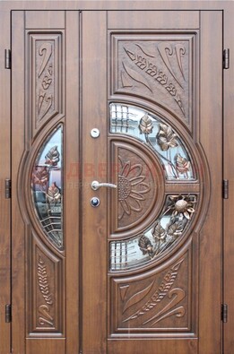 Уличная дверь в цвете Итальянский орех с виноритом и ковкой со стеклом ДВТ-147 в Одинцово